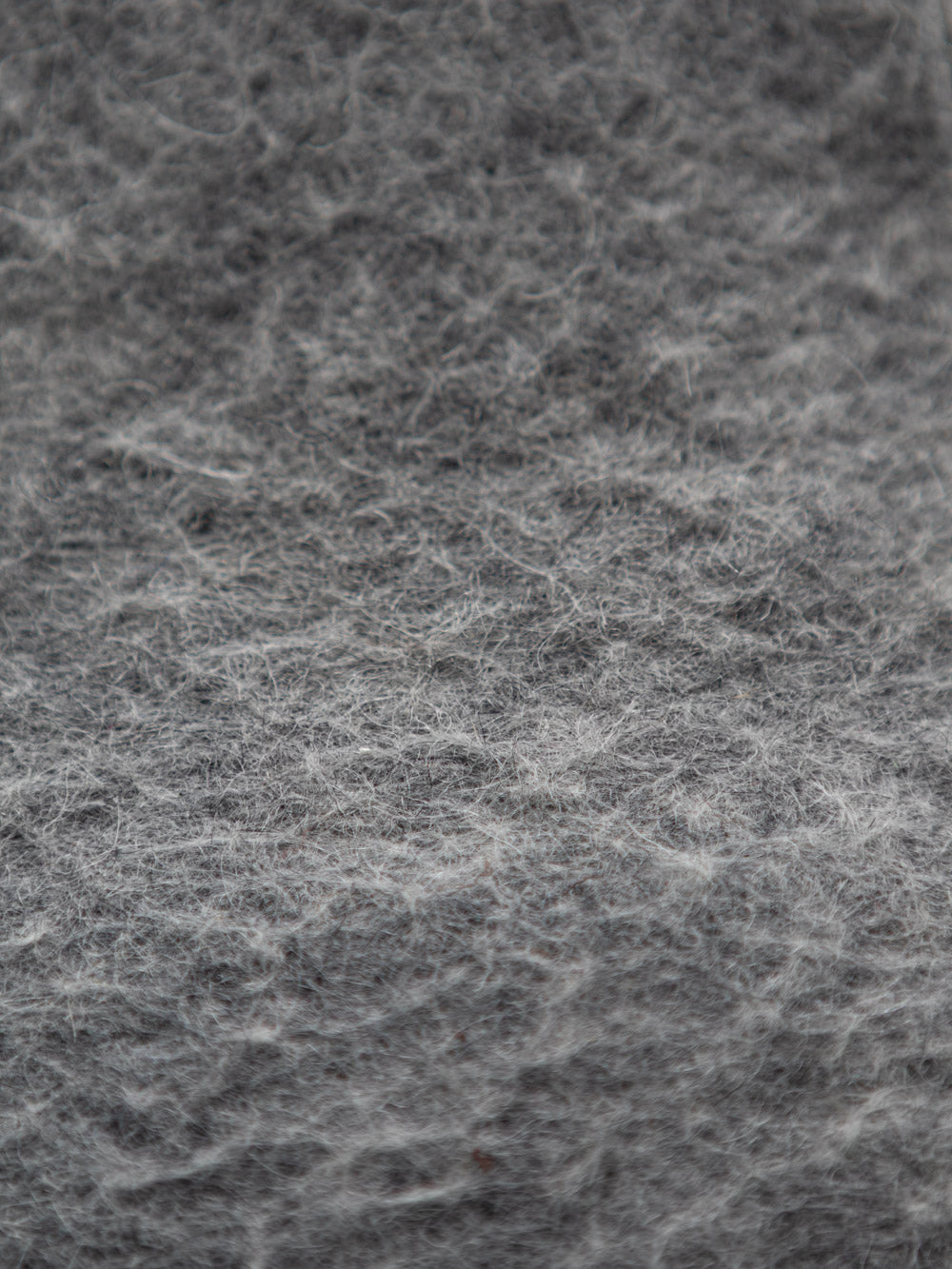 Detail von grauer Wolle von Merinoschafen. 